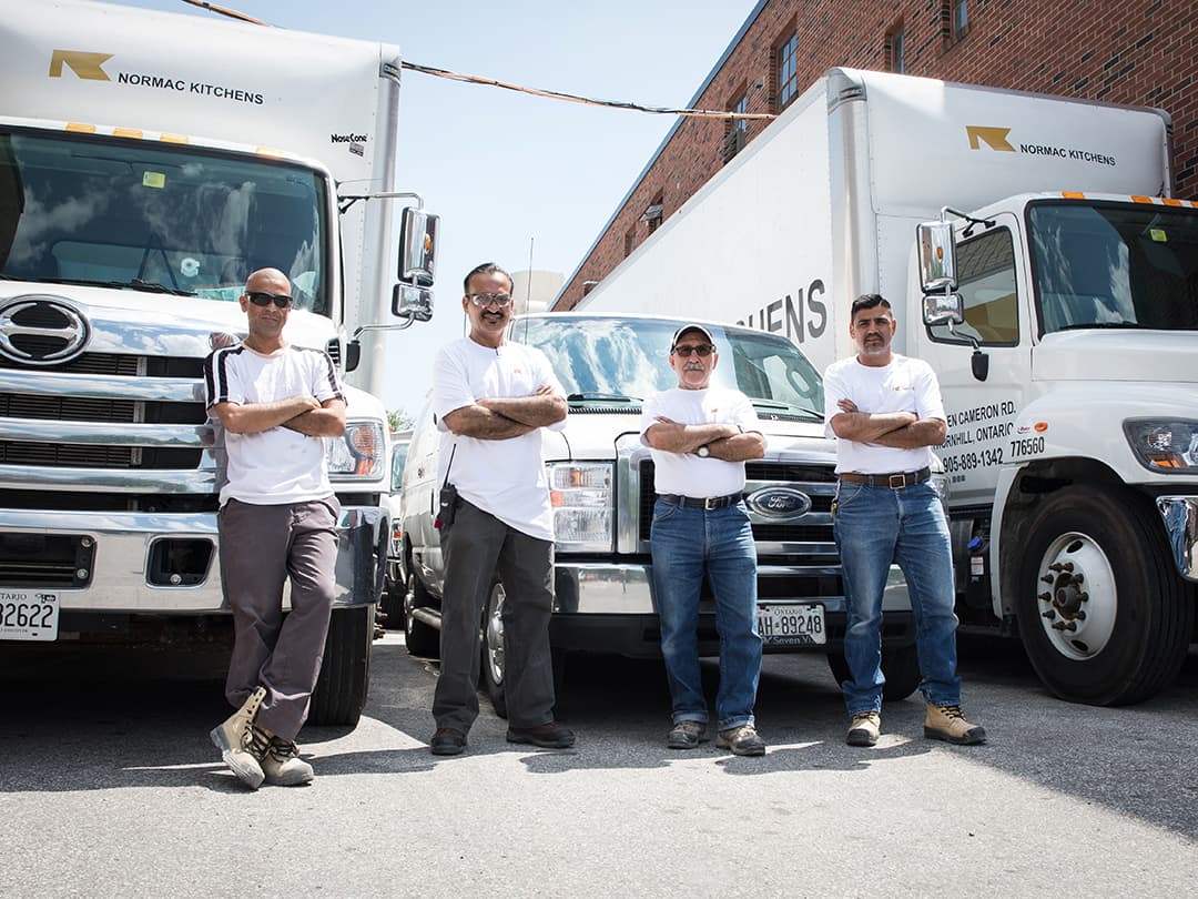 Normac employees standing in front of trucks